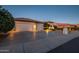 Two-car garage and well-lit front yard with desert landscaping at 16442 W Quarry Ct, Surprise, AZ 85374