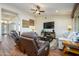 Comfortable living room with hardwood floors and a large TV at 16442 W Quarry Ct, Surprise, AZ 85374