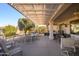 Relaxing covered patio with multiple seating areas at 16442 W Quarry Ct, Surprise, AZ 85374