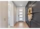 Modern hallway with dark accent wall and wood-look flooring at 17674 E Fort Verde Rd, Rio Verde, AZ 85263