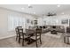 Open dining room with wood table and gray sectional sofa at 1830 S Yucca St, Chandler, AZ 85286