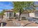 One-story house with tan exterior, tile roof, and landscaped yard at 1830 S Yucca St, Chandler, AZ 85286