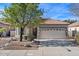 One-story house with tan exterior, tile roof, and landscaped yard at 1830 S Yucca St, Chandler, AZ 85286