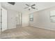 Primary bedroom with carpeted floor, ceiling fan and en-suite bathroom at 19457 W Highland Ave, Litchfield Park, AZ 85340