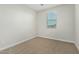 Simple bedroom with window and carpet flooring at 19457 W Highland Ave, Litchfield Park, AZ 85340