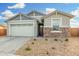 Charming one-story house with a two-car garage and stone accents at 19457 W Highland Ave, Litchfield Park, AZ 85340