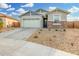 Newly built home with a two-car garage and landscaped yard at 19457 W Highland Ave, Litchfield Park, AZ 85340