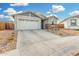 New construction home with a two-car garage and desert landscaping at 19457 W Highland Ave, Litchfield Park, AZ 85340