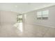 Bright living room with tile floors and sliding glass door leading to backyard at 19457 W Highland Ave, Litchfield Park, AZ 85340