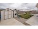 Landscaped backyard with shed, playset, and grassy area at 19726 W Morning Glory St, Buckeye, AZ 85326