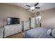 Bright bedroom with a TV, dresser and ensuite bathroom access at 19726 W Morning Glory St, Buckeye, AZ 85326