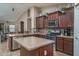 Spacious kitchen with dark wood cabinets and granite countertops at 19726 W Morning Glory St, Buckeye, AZ 85326