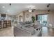 Bright and airy living room with open floor plan to kitchen at 19726 W Morning Glory St, Buckeye, AZ 85326