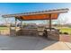 Community BBQ area with a covered pavilion and grill at 21622 E Via De Arboles --, Queen Creek, AZ 85142