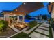 Outdoor kitchen and dining area with fire pit, adjacent to a sparkling pool at 21622 E Via De Arboles --, Queen Creek, AZ 85142