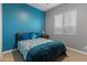 Bedroom with double bed, teal accent wall, and window blinds at 21622 E Via De Arboles --, Queen Creek, AZ 85142