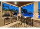 Stainless steel grill, bar seating, and mini-fridge in the outdoor kitchen at 21622 E Via De Arboles --, Queen Creek, AZ 85142