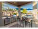 Outdoor kitchen with grill, mini-fridge, and seating overlooking the pool at 21622 E Via De Arboles --, Queen Creek, AZ 85142