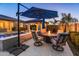 Relaxing patio with fire pit table and umbrella, near the pool at 21622 E Via De Arboles --, Queen Creek, AZ 85142