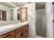 Clean bathroom with a shower, tiled walls, and wood vanity at 22206 N La Senda Dr, Scottsdale, AZ 85255