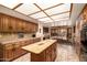 Bright kitchen with island, dining area, and wood cabinets at 22206 N La Senda Dr, Scottsdale, AZ 85255