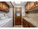 Laundry room with washer, dryer, and ample cabinet space at 22206 N La Senda Dr, Scottsdale, AZ 85255