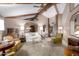 Living area with beamed ceiling, plush seating, and a large window at 22206 N La Senda Dr, Scottsdale, AZ 85255