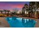 Expansive pool reflecting the sunset sky at 22206 N La Senda Dr, Scottsdale, AZ 85255