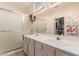 Bright bathroom with a dual-sink vanity, closet and glass shower at 22801 N Las Vegas Dr, Sun City West, AZ 85375