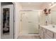 Bathroom featuring a glass-enclosed shower, a walk-in closet, and ample vanity storage at 22801 N Las Vegas Dr, Sun City West, AZ 85375