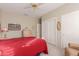 Bedroom with a red comforter, dresser, sliding closet door and neutral colored walls at 22801 N Las Vegas Dr, Sun City West, AZ 85375