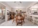 Cozy dining room featuring a wood table, upholstered chairs, and easy access to the kitchen at 22801 N Las Vegas Dr, Sun City West, AZ 85375