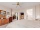 Spacious main bedroom with a ceiling fan, ensuite bathroom, and a cozy reading nook at 22801 N Las Vegas Dr, Sun City West, AZ 85375