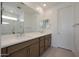 Bathroom with a double sink vanity and a large mirror, offering a modern and functional space at 24248 W Agora Ln, Buckeye, AZ 85326