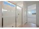 Modern walk-in shower with glass enclosure, bright lighting, and sleek tile work in the bathroom at 24248 W Agora Ln, Buckeye, AZ 85326