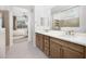 Spa-like bathroom with double vanity, large shower, and view of bedroom at 24248 W Agora Ln, Buckeye, AZ 85326