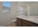 Well-lit bathroom showcasing a modern vanity, sink, and window with natural light at 24248 W Agora Ln, Buckeye, AZ 85326