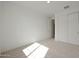 Bright, carpeted bedroom with closet, white walls, and abundant natural light at 24248 W Agora Ln, Buckeye, AZ 85326