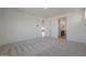 Carpeted bedroom with neutral walls leading to an ensuite bathroom and walk-in closet at 24248 W Agora Ln, Buckeye, AZ 85326