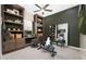 Home office with built-in shelving and exercise bike at 24248 W Agora Ln, Buckeye, AZ 85326