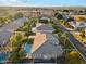 An aerial view showcases a home with a backyard pool, lush landscaping, and a serene neighborhood setting at 2625 N 24Th St # 36, Mesa, AZ 85213