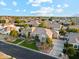 An aerial view showcases a well-manicured home with palm trees, lush landscaping, and a spacious driveway at 2625 N 24Th St # 36, Mesa, AZ 85213