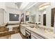 Bright bathroom featuring double sinks and a standalone tub with decorative light fixtures at 2625 N 24Th St # 36, Mesa, AZ 85213