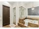 Primary bathroom featuring a standalone tub with steps, a separate shower, and a decorative chandelier at 2625 N 24Th St # 36, Mesa, AZ 85213