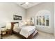 Neutral tone bedroom with a wooden bed frame and a built in window with shutters at 2625 N 24Th St # 36, Mesa, AZ 85213