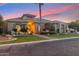 Inviting single-story home boasts desert landscaping, arched entryway and windows and beautiful desert sunset at 2625 N 24Th St # 36, Mesa, AZ 85213