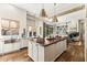 Bright kitchen with hardwood floors, a butcher block island, modern light fixtures, and fireplace at 2625 N 24Th St # 36, Mesa, AZ 85213