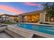 Backyard pool featuring travertine tile surround, patio seating, fire pit and desert landscaping at 2625 N 24Th St # 36, Mesa, AZ 85213