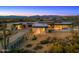 Expansive aerial view of a modern home with a pool, desert landscaping, and stunning mountain views at 28110 N 96Th Pl, Scottsdale, AZ 85262