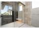 Spa-like bathroom with glass shower and stone feature wall at 28110 N 96Th Pl, Scottsdale, AZ 85262